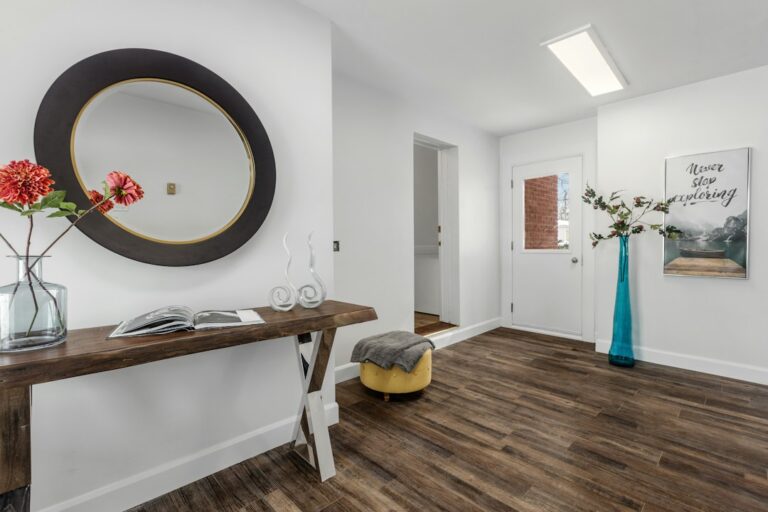 A busy home entryway with durable flooring, boots, a doormat, and a family walking indoors.